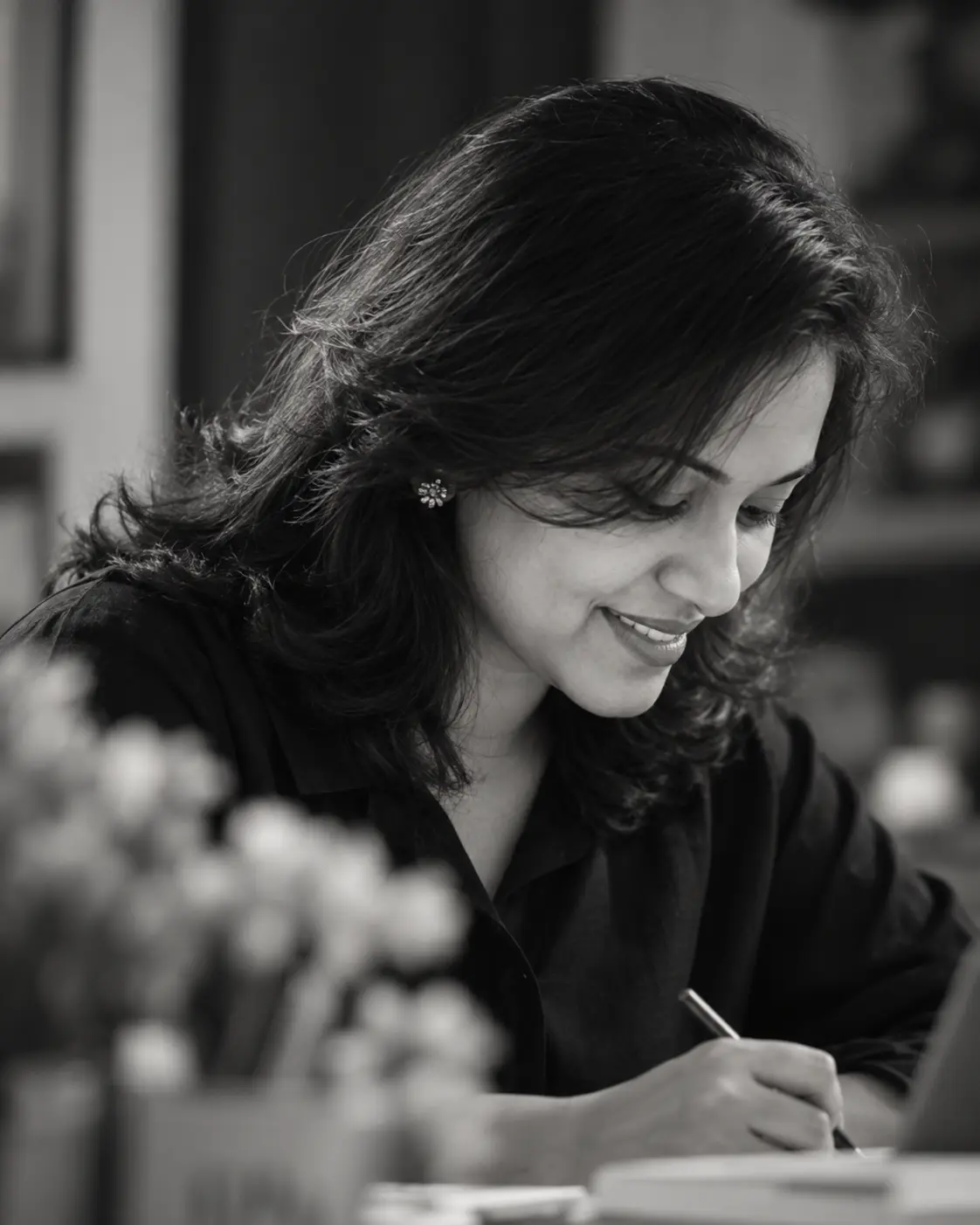 Anu working thoughtfully at a desk
